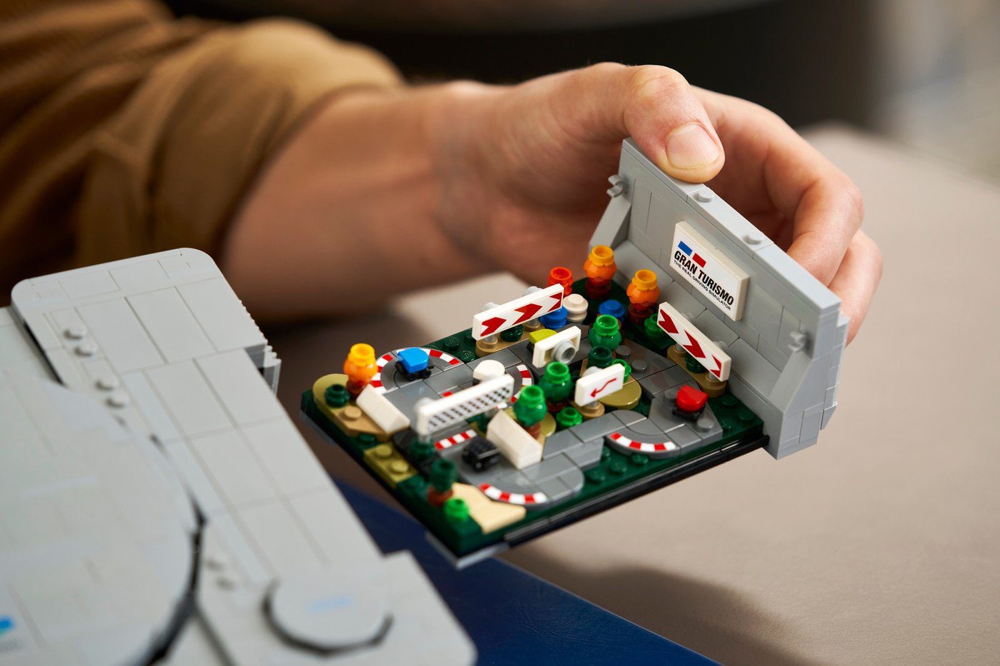 Hidden Gran Turismo diorama inside LEGO PlayStation 72306 held in one hand